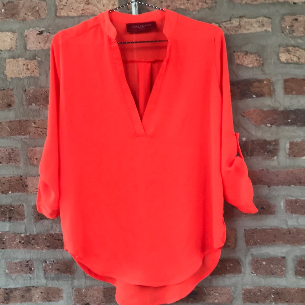 Small bright orange Akira top